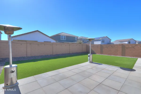 a view of a house with backyard and porch