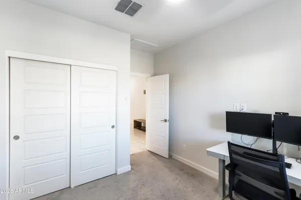 a bedroom with a workspace