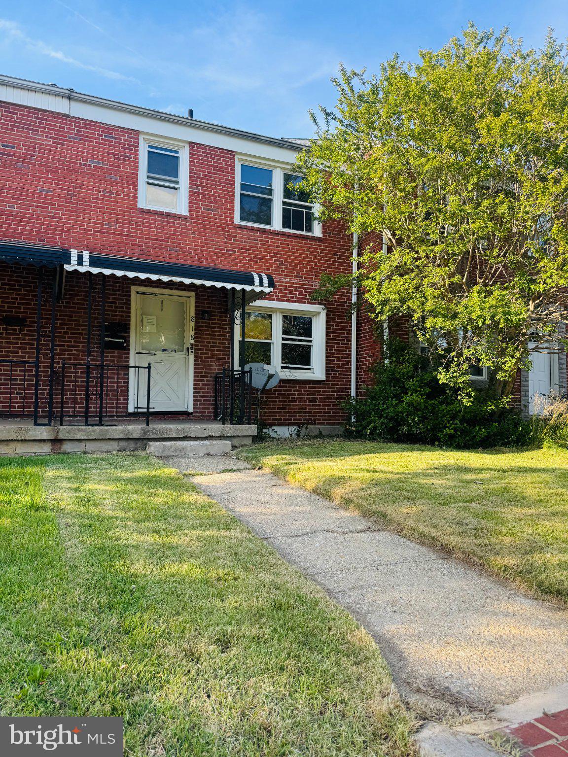 818 Bradhurst Road Baltimore, MD 21212 - Photo 2 of 5 Charming brick home with lush greenery.