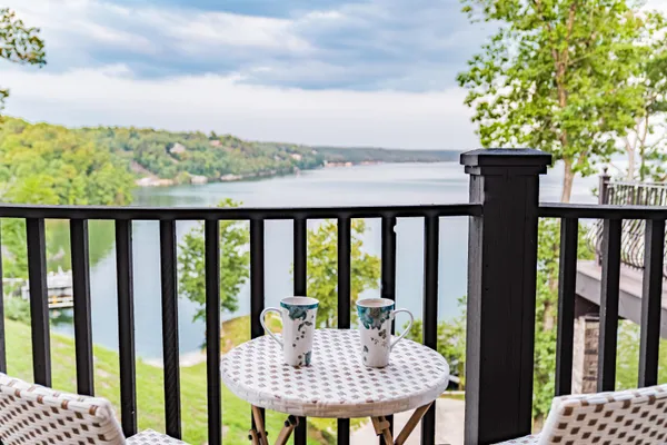 a view of a balcony with mountain view and wooden floor