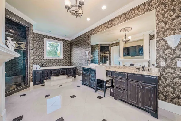 a bathroom with a double vanity sink mirror and bathtub