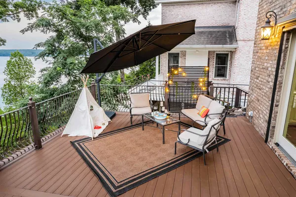 a view of a roof deck with chair and wooden floor