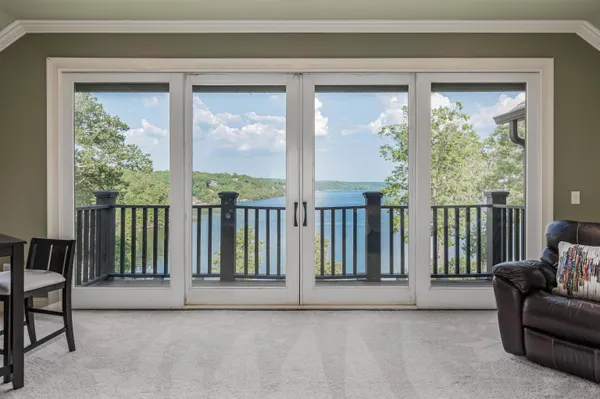 a view of a livingroom with furniture and floor to ceiling window