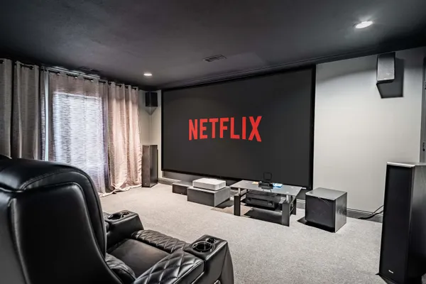 a bedroom with bed and a large window