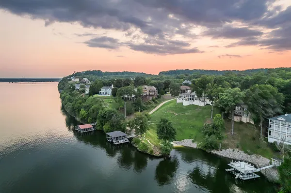 an aerial view of a houses with a lake view