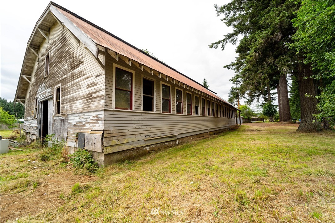 237 Hatchery Road Chehalis, WA 98532 - Photo 26 of 30 a view of house with backyard and trees in the background
