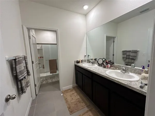 a bathroom with a double vanity sink and mirror