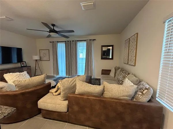 a living room with furniture and a large window