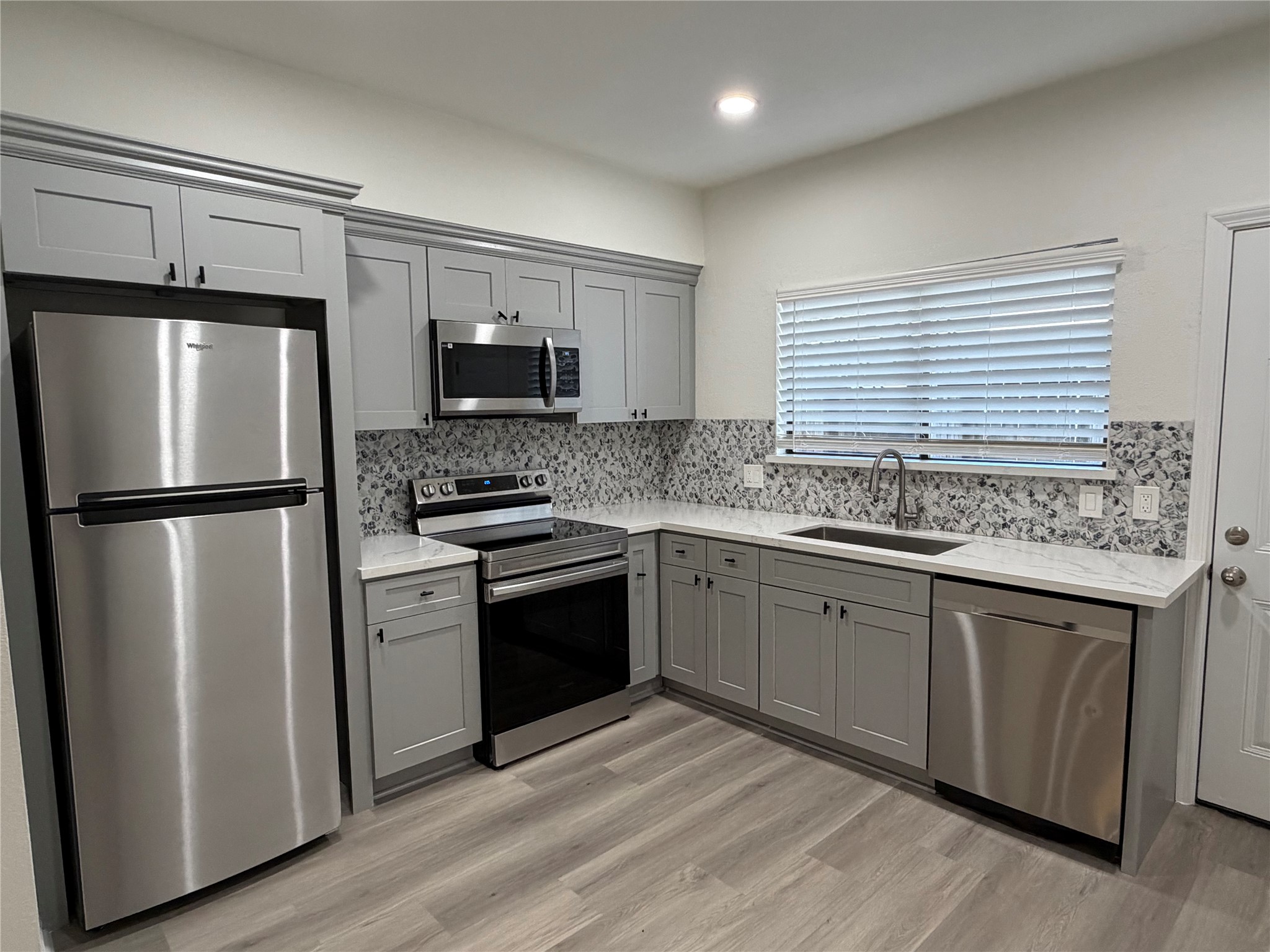 6401 Deihl Road, Unit 606 Houston, TX 77092 - Photo 1 of 21 a kitchen with granite countertop a refrigerator and a sink