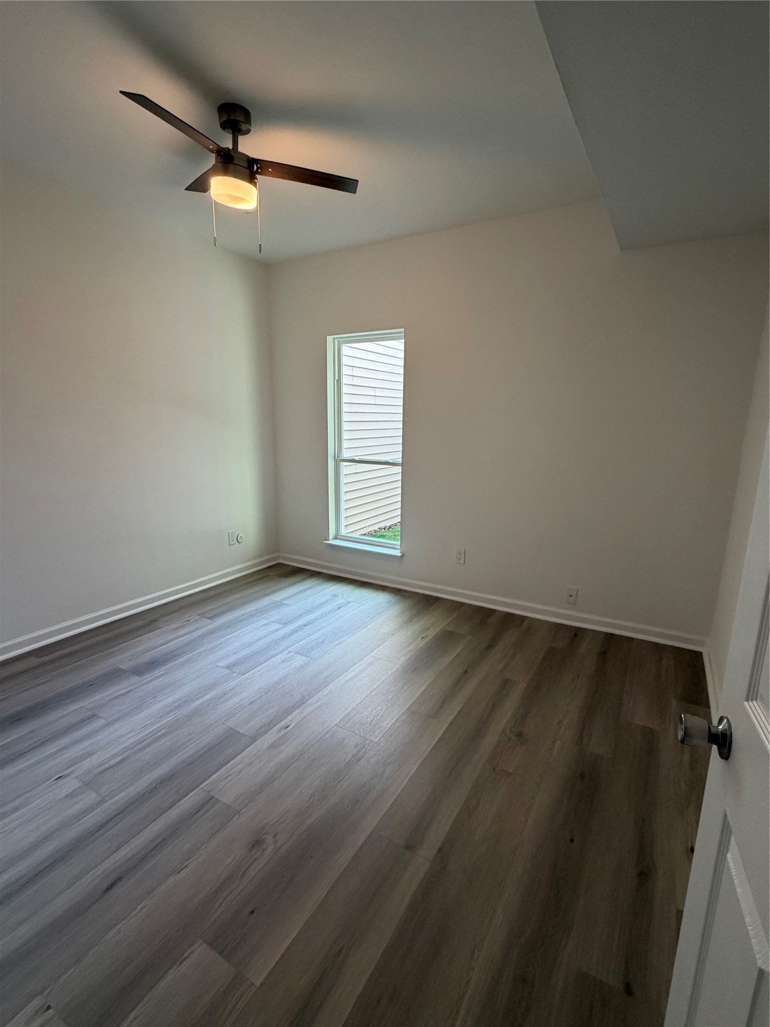 6401 Deihl Road, Unit 606 Houston, TX 77092 - Photo 12 of 21 an empty room with wooden floor fan and windows