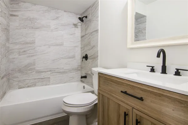 a bathroom with a sink a toilet and a bathtub