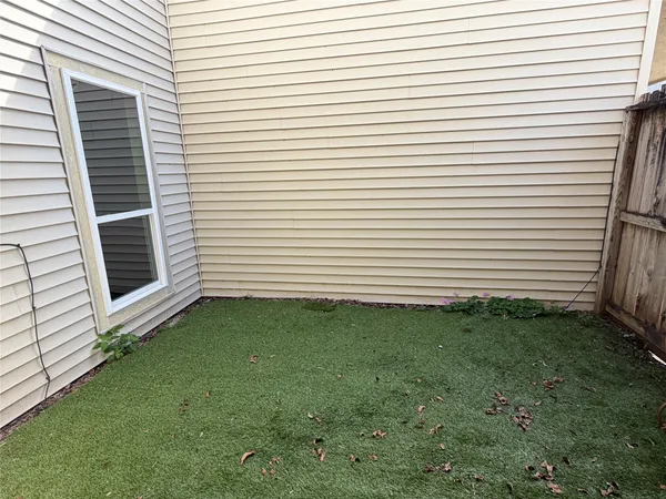 a view of a white house with a yard