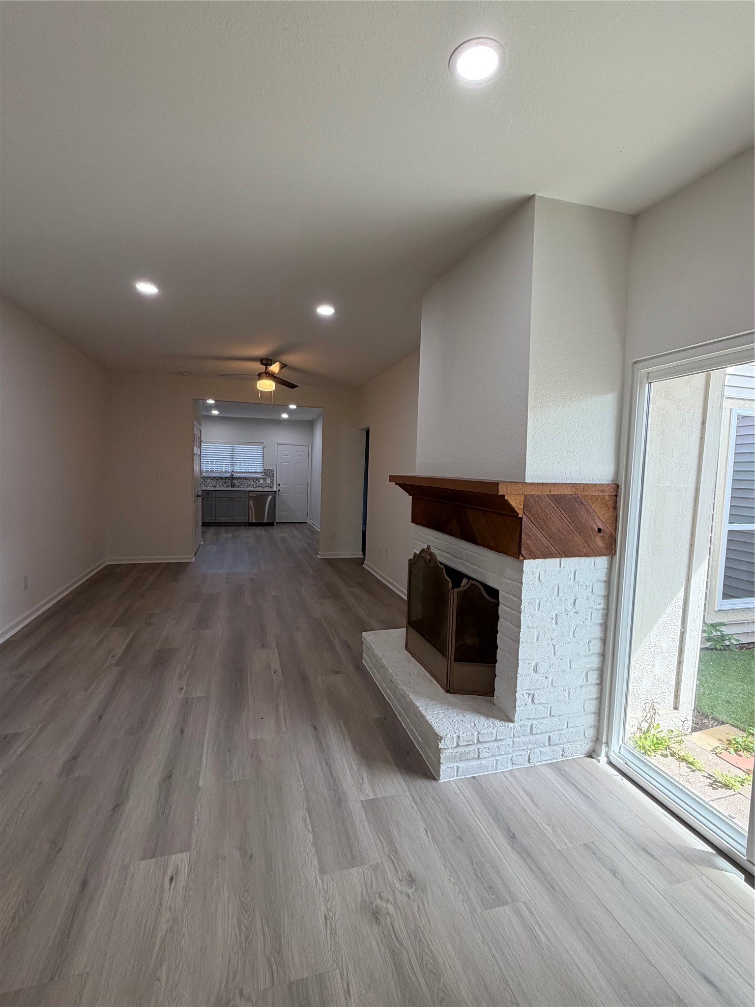 6401 Deihl Road, Unit 606 Houston, TX 77092 - Photo 5 of 21 an empty room with wooden floor fireplace and windows