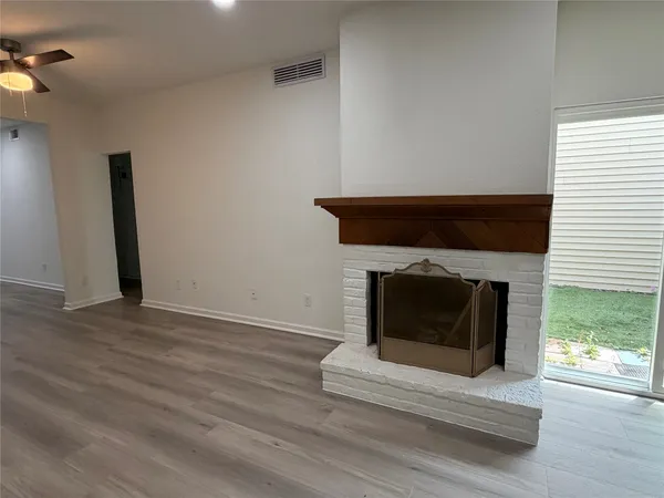 a living room with a fireplace and a wooden floor