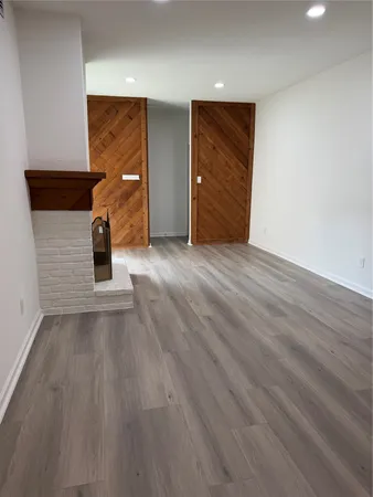 an empty room with wooden floor and closet