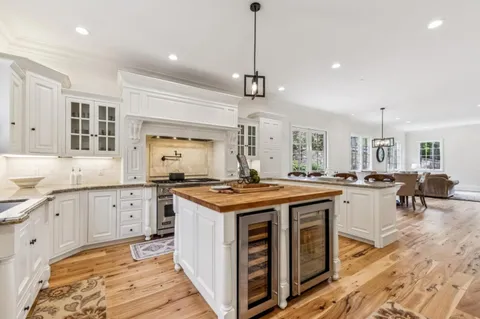 a dining room with furniture and a floor to ceiling window
