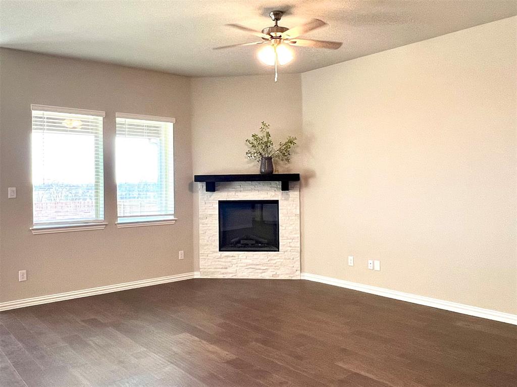 3305 Cross Shr Drive Anna, TX 75409 - Photo 9 of 31 Unfurnished living room with ceiling fan, dark hardwood / wood-style flooring, and a fireplace