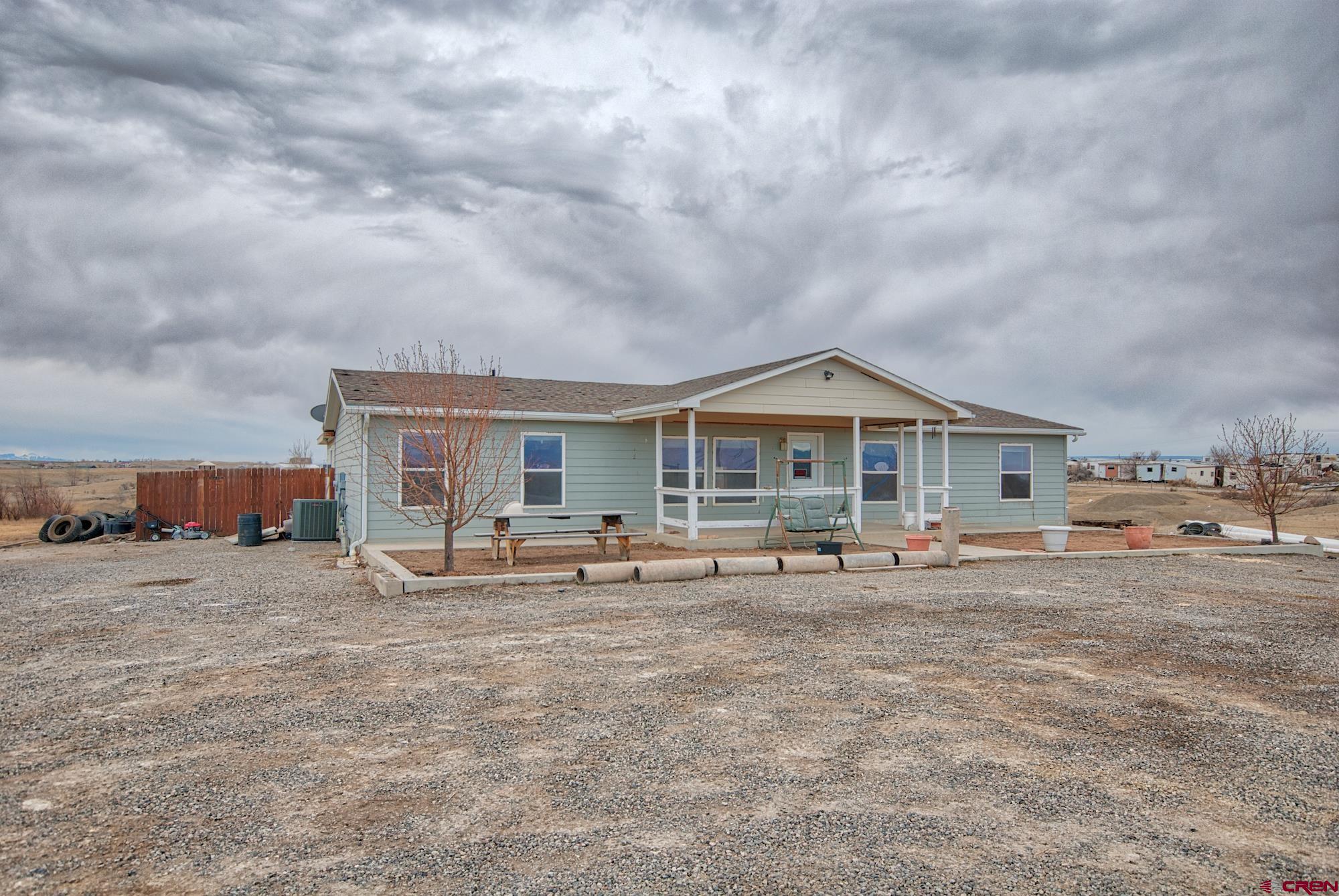 21548 F Road Delta, CO 81416 - Photo 2 of 21 a backyard of a house with table and chairs