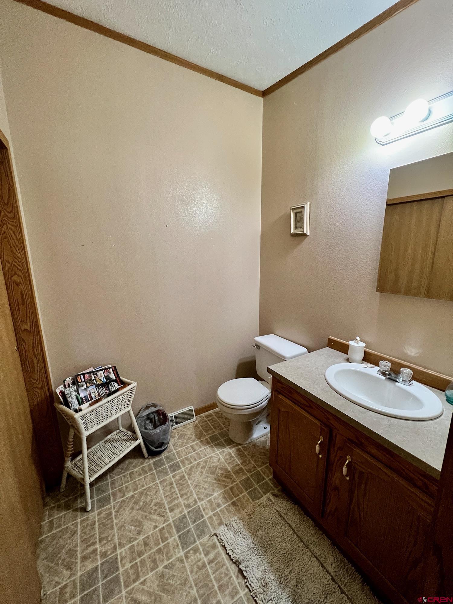 21548 F Road Delta, CO 81416 - Photo 6 of 21 a bathroom with a toilet a sink and mirror