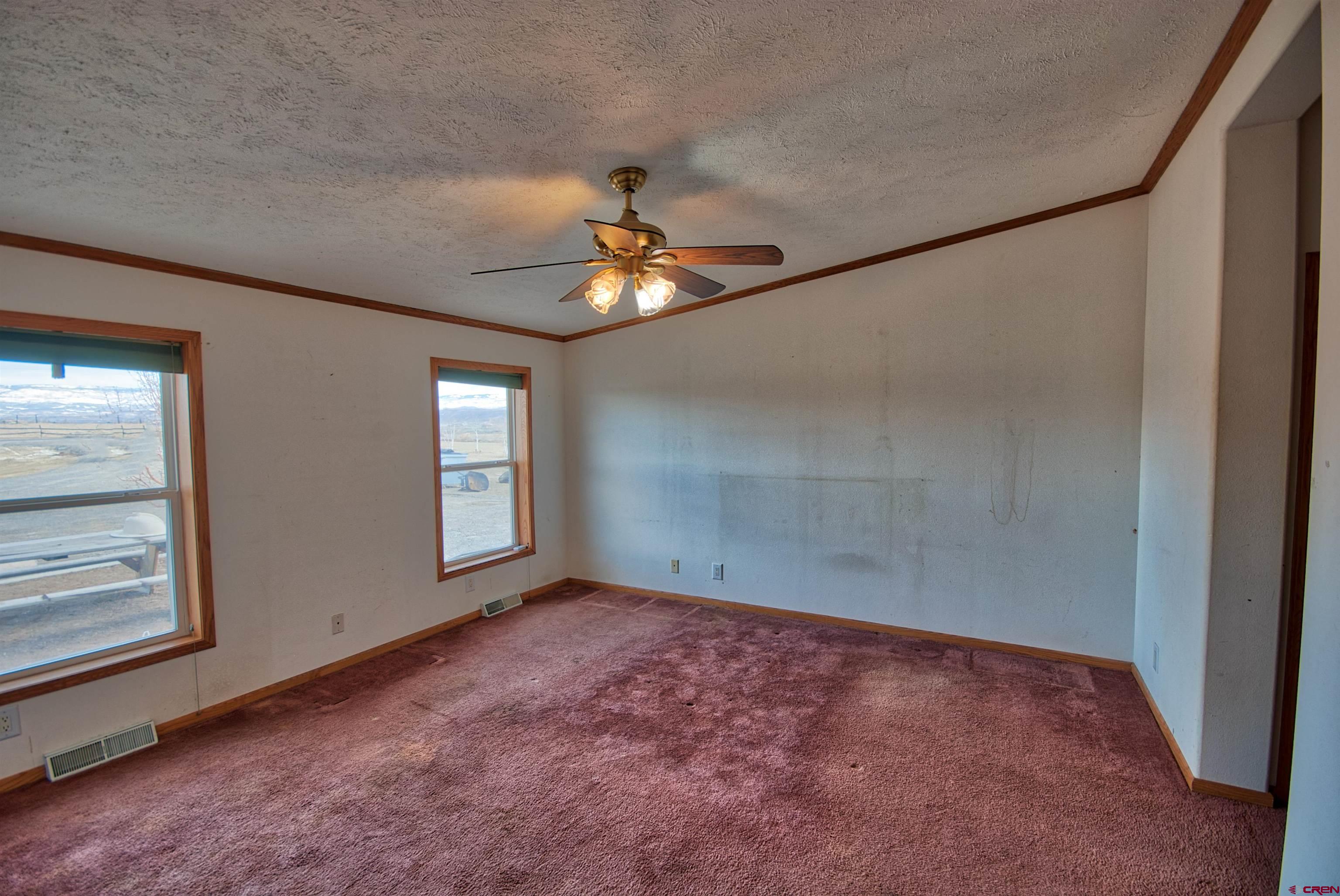 21548 F Road Delta, CO 81416 - Photo 8 of 21 an empty room with fan and windows