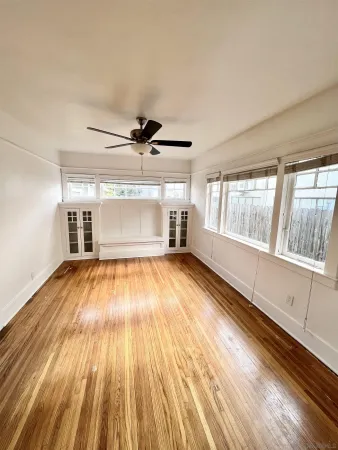 wooden floor in an empty room with a window