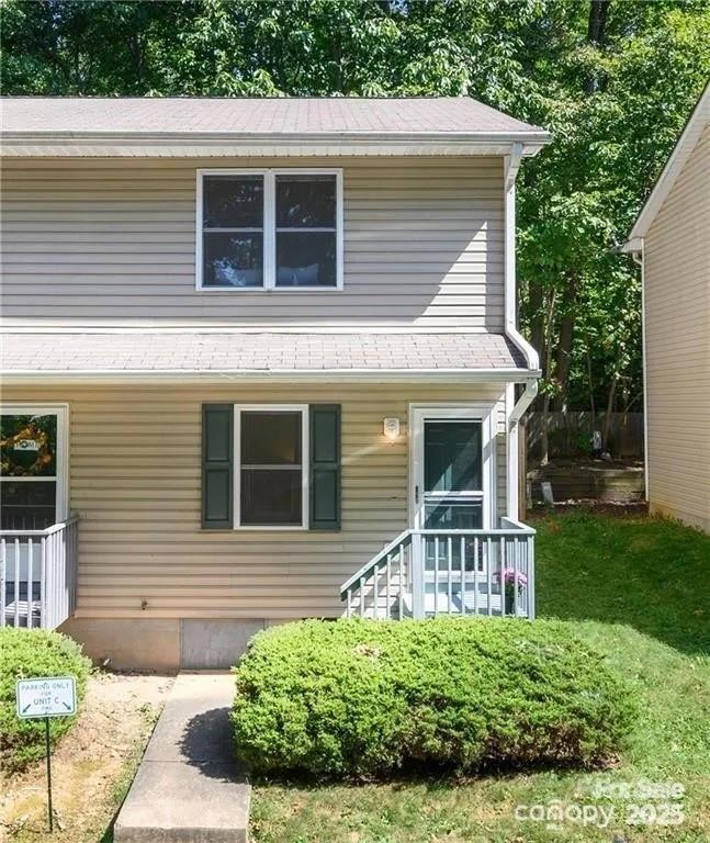 6 Azalea Road, Unit C Arden, NC 28704 - Photo 2 of 11 a front view of a house with a yard