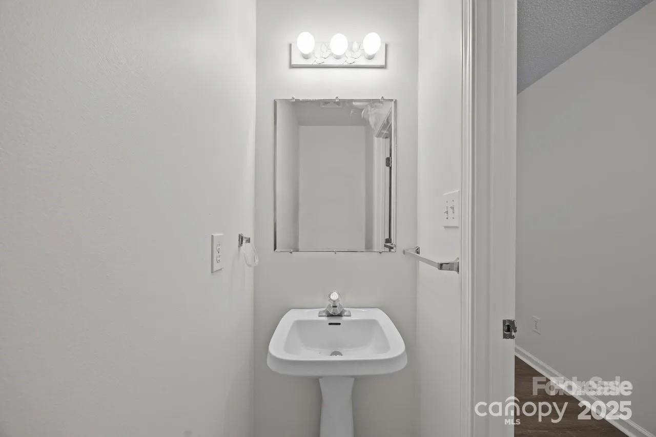 6 Azalea Road, Unit C Arden, NC 28704 - Photo 7 of 11 a bathroom with a sink and a mirror