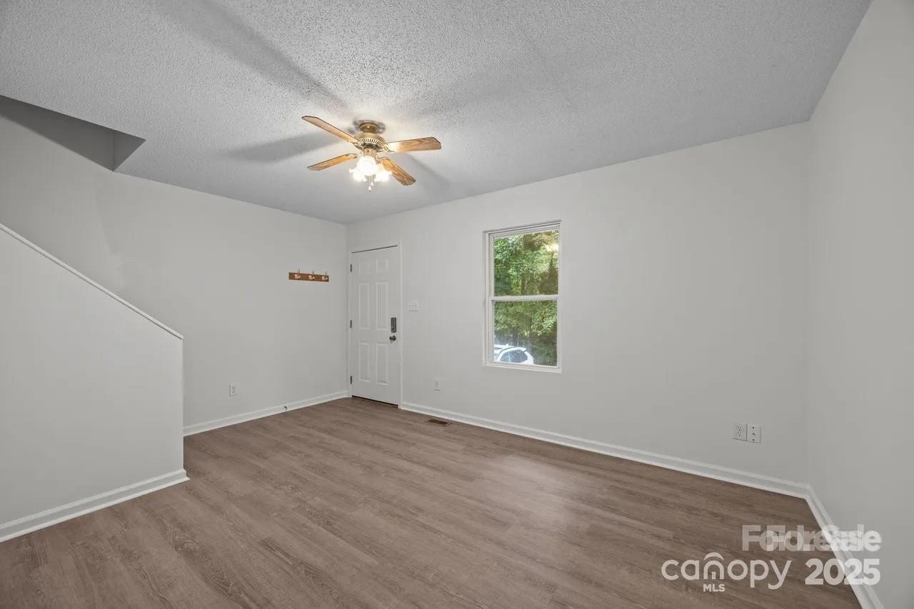 6 Azalea Road, Unit C Arden, NC 28704 - Photo 9 of 11 an empty room with a window and a fan