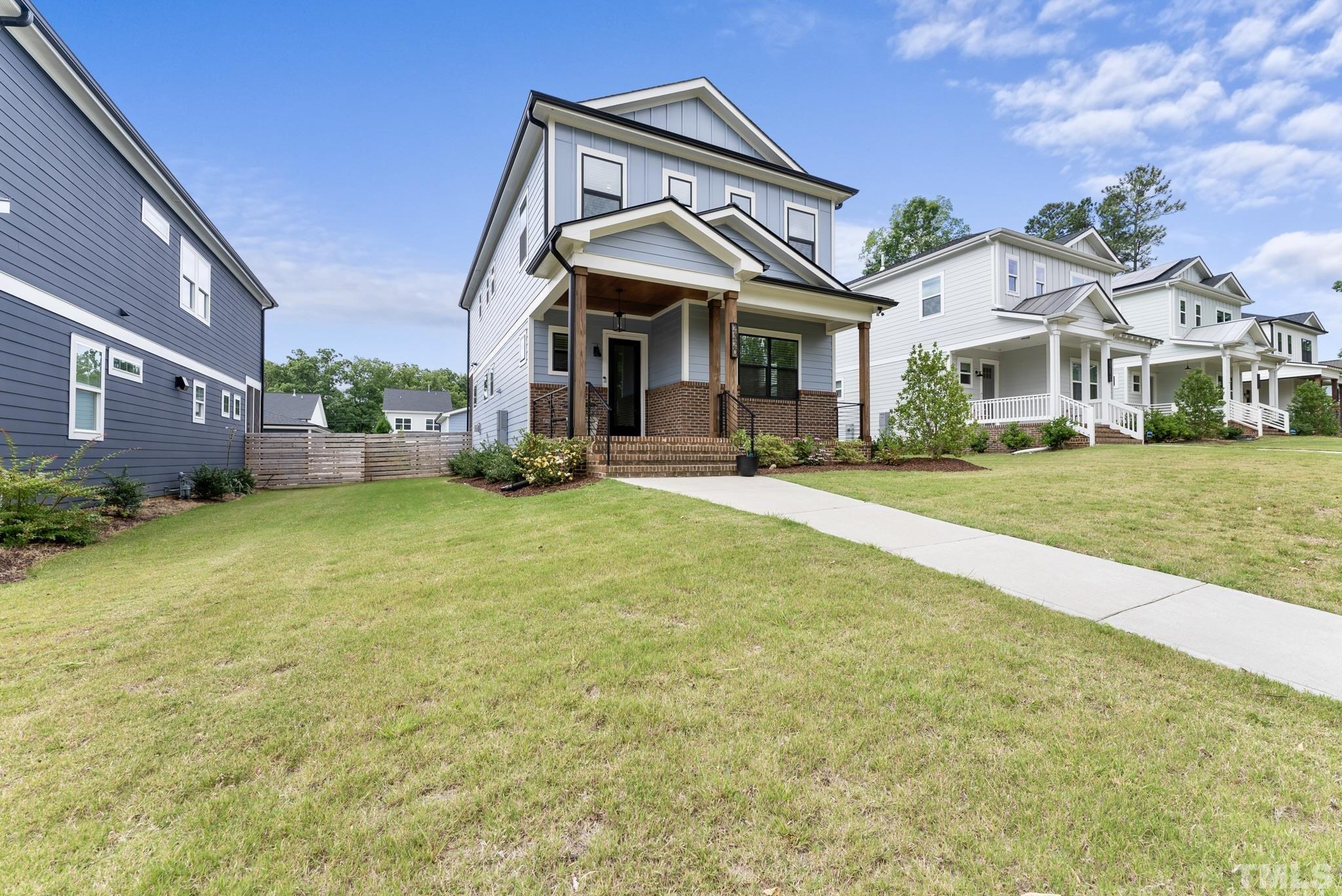 2320 Milburnie Road Raleigh, NC 27610 - Photo 3 of 40 a front view of a house with a yard