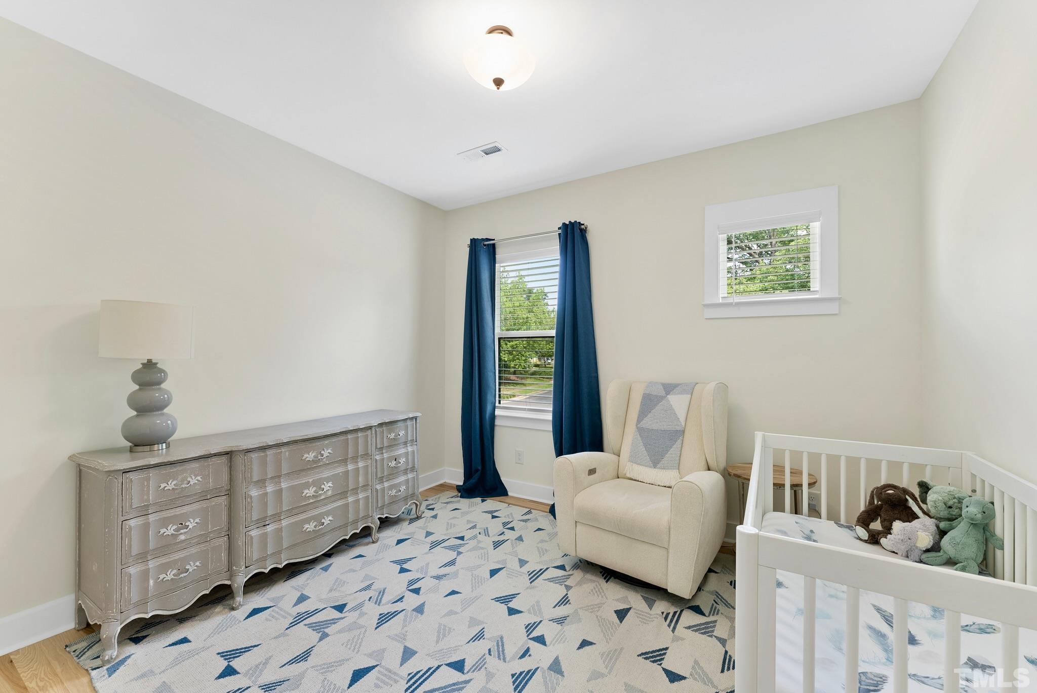 2320 Milburnie Road Raleigh, NC 27610 - Photo 31 of 40 a bedroom with furniture and wooden floor