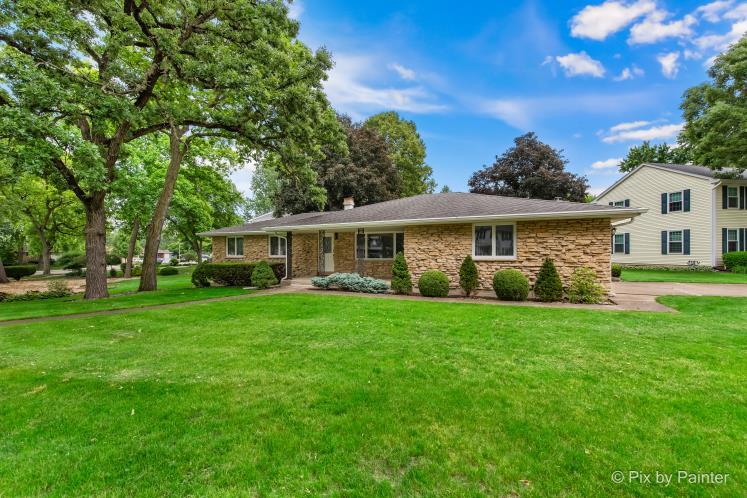 195 Westgate Drive Elgin, IL 60123 - Photo 1 of 39 a front view of a house with a garden