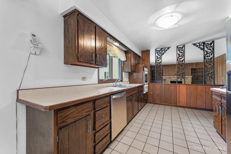 195 Westgate Drive Elgin, IL 60123 - Photo 13 of 39 a kitchen with stainless steel appliances granite countertop a sink counter space and cabinets
