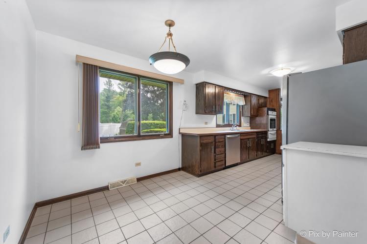 195 Westgate Drive Elgin, IL 60123 - Photo 14 of 39 a kitchen with stainless steel appliances a sink and a stove