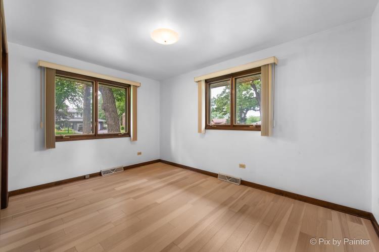 195 Westgate Drive Elgin, IL 60123 - Photo 18 of 39 an empty room with wooden floor and windows