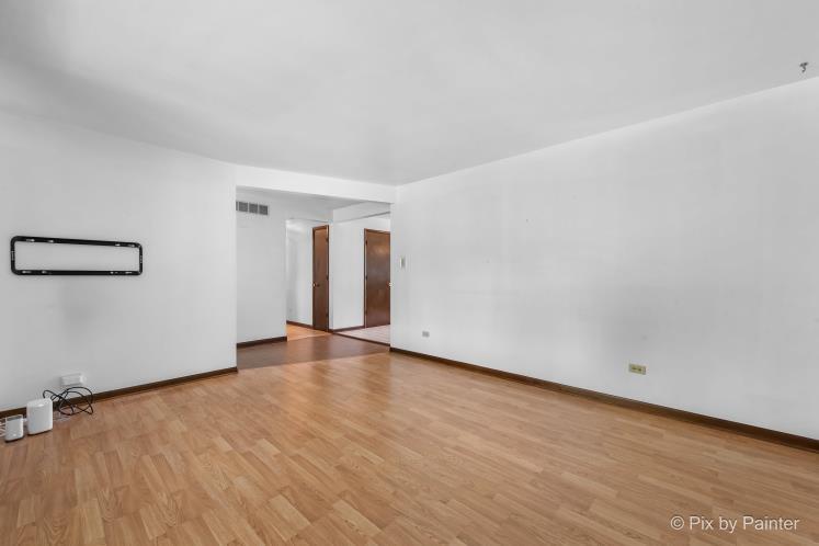 195 Westgate Drive Elgin, IL 60123 - Photo 7 of 39 a view of an empty room with wooden floor and a window
