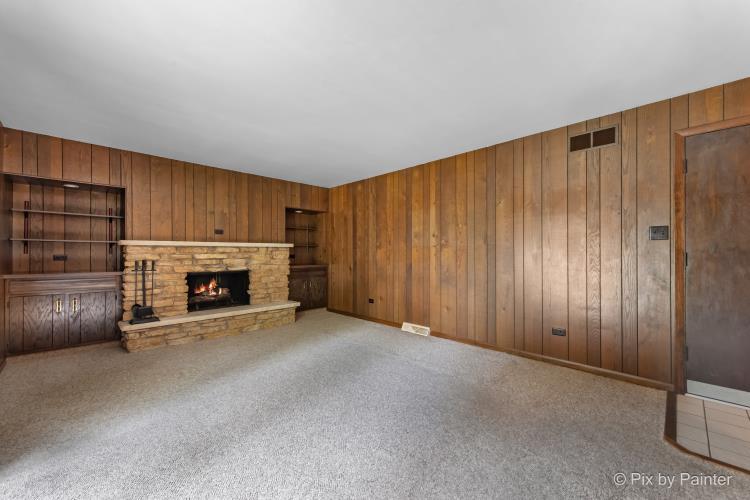 195 Westgate Drive Elgin, IL 60123 - Photo 8 of 39 an empty room with furniture and fireplace