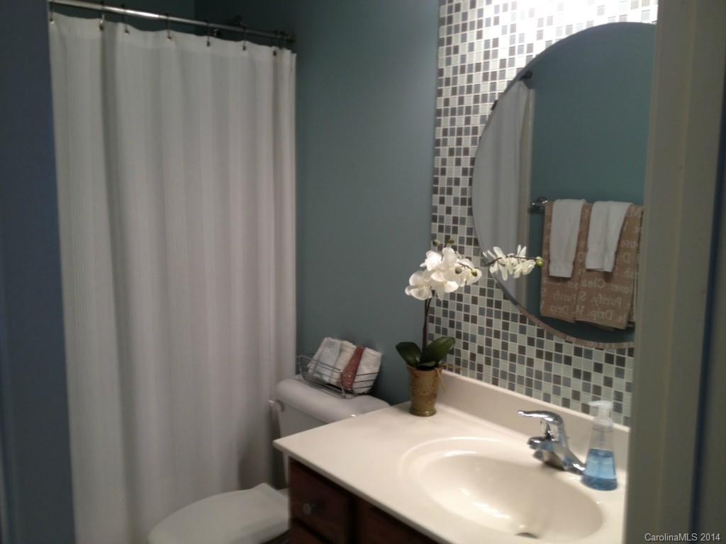 411 Bull Finch Bend Fort Mill, SC 29708 - Photo 15 of 22 a bathroom with a sink and mirror
