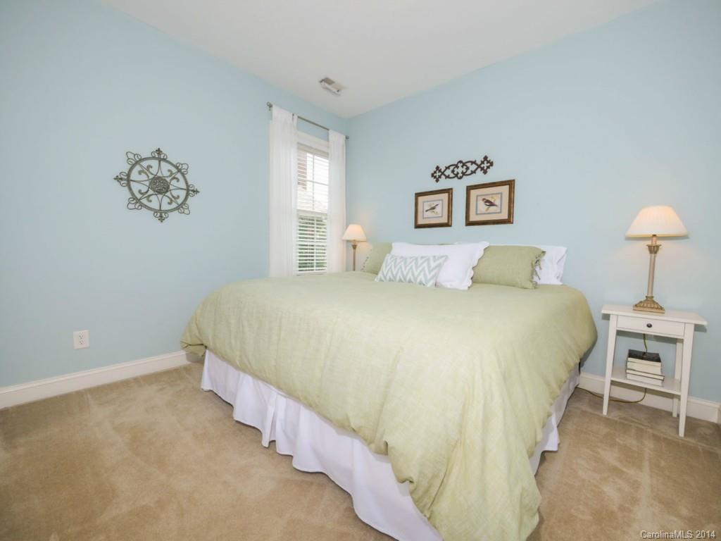 411 Bull Finch Bend Fort Mill, SC 29708 - Photo 16 of 22 a bedroom with a bed and a lamp