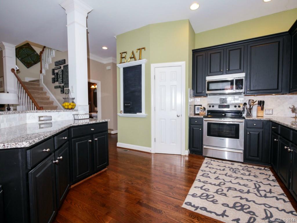 411 Bull Finch Bend Fort Mill, SC 29708 - Photo 6 of 22 a kitchen with stainless steel appliances granite countertop a stove refrigerator and cabinets