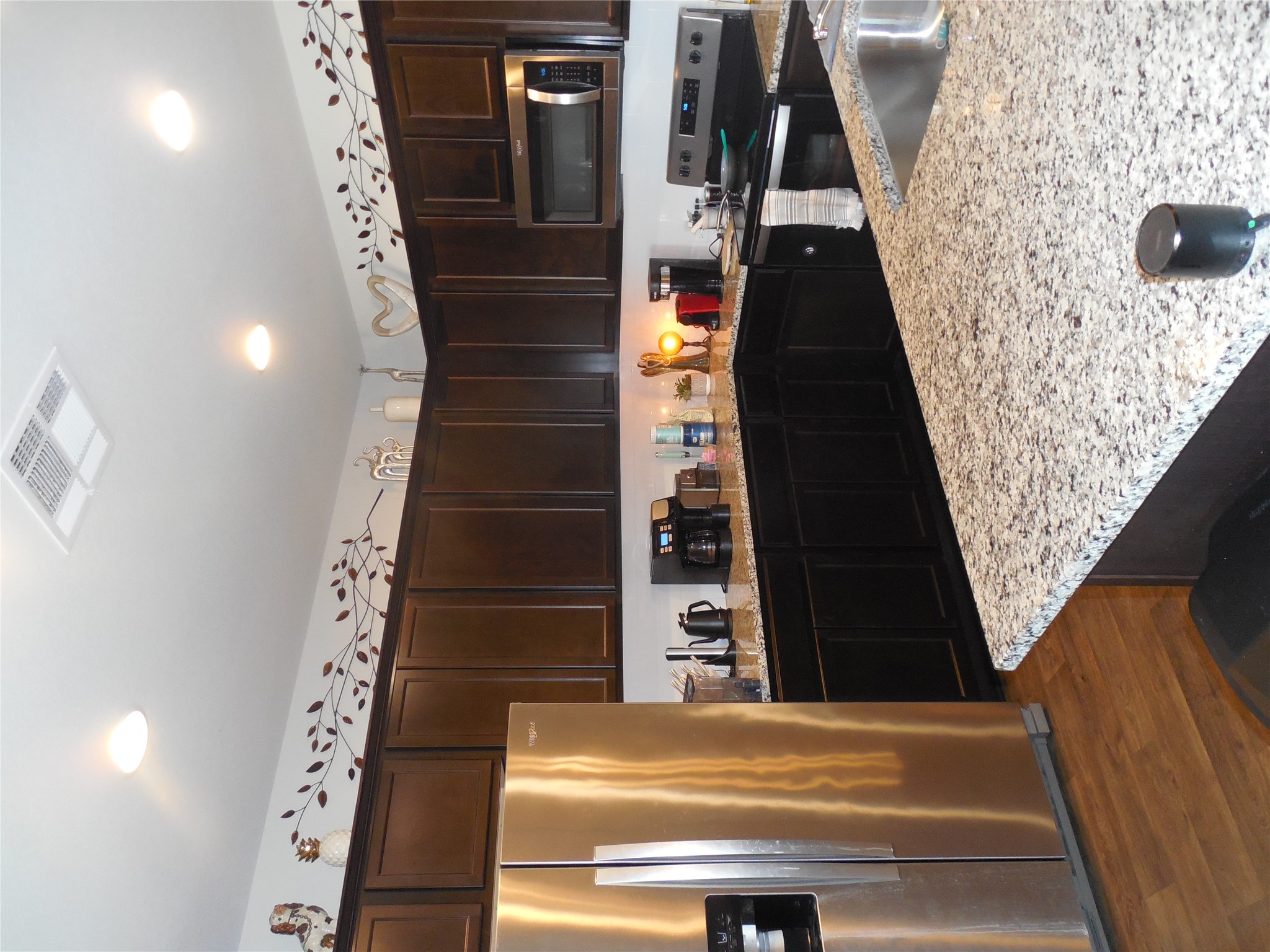 1009 Ferryman Drive Georgetown, TX 78626 - Photo 20 of 24 a kitchen with stainless steel appliances wooden cabinets a refrigerator and a stove
