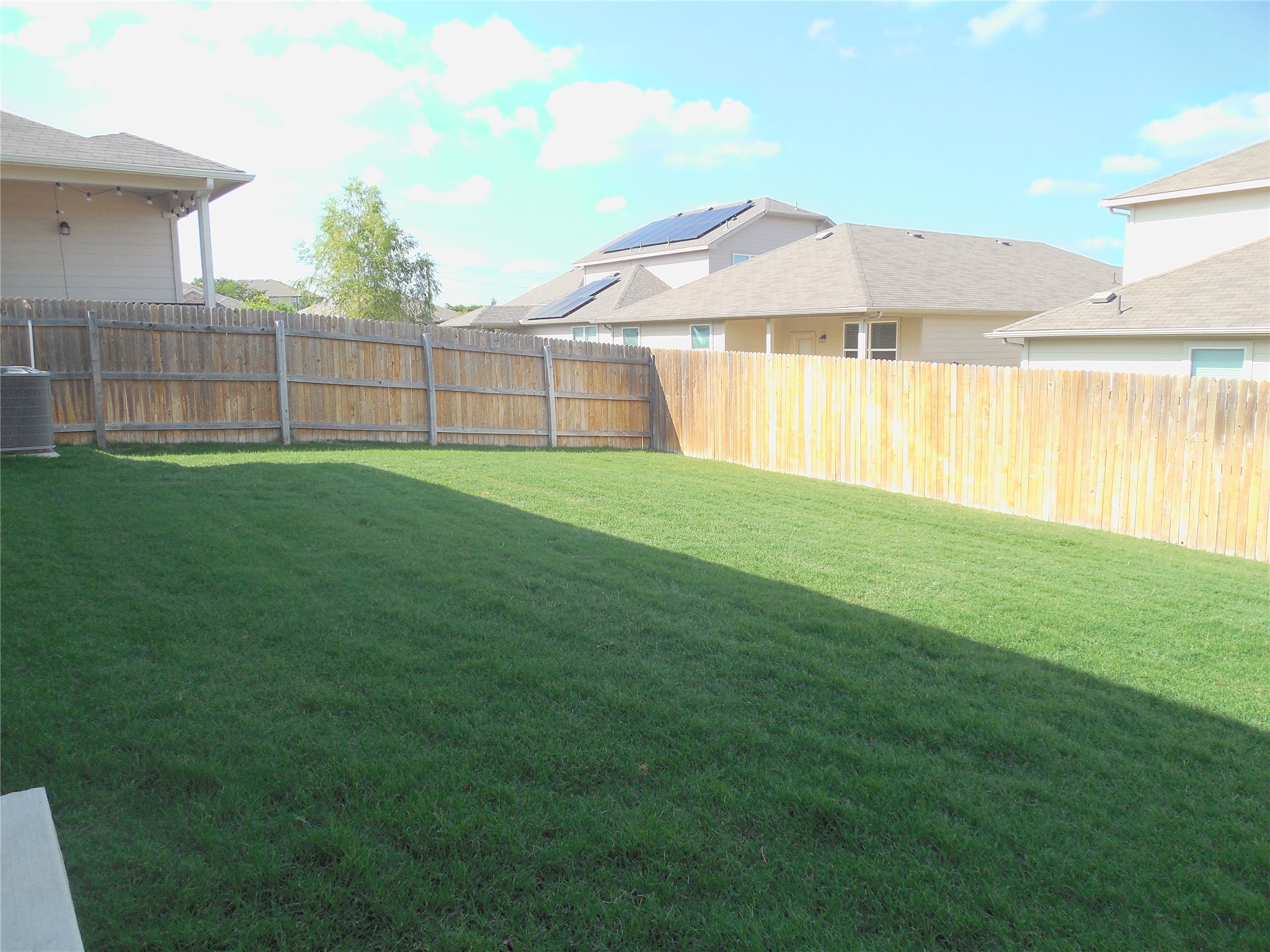 1009 Ferryman Drive Georgetown, TX 78626 - Photo 22 of 24 a view of a house with a backyard and a tub