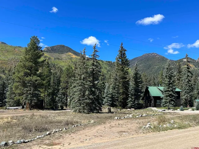 a view of a house with a backyard of a house