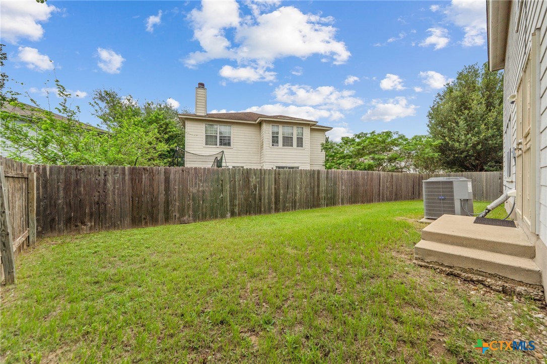 109 Comal Cove Elgin, TX 78621 - Photo 31 of 34 a view of a backyard with green space
