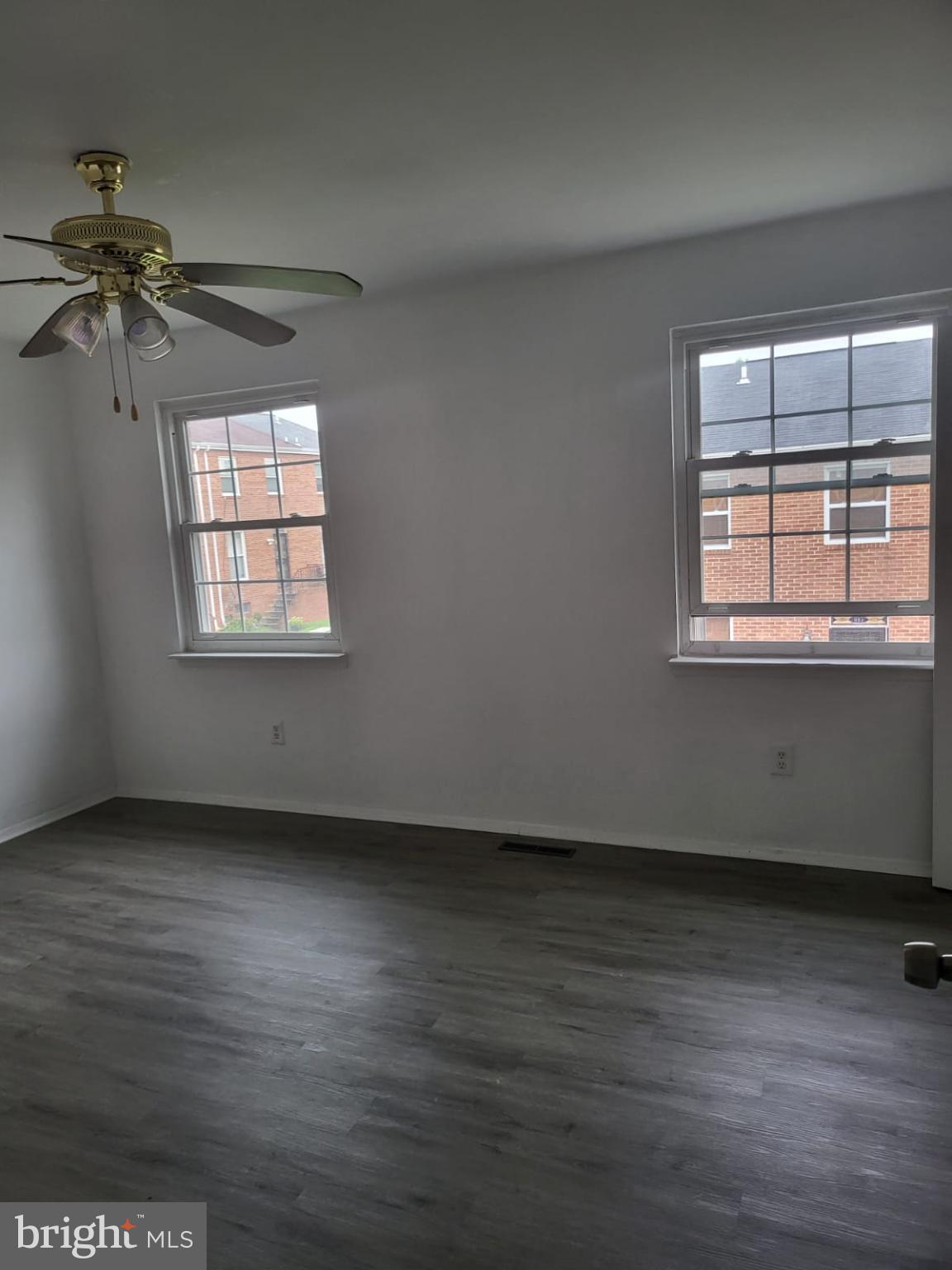 1129 Willinger Court Baltimore, MD 21202 - Photo 11 of 26 an empty room with wooden floor and windows