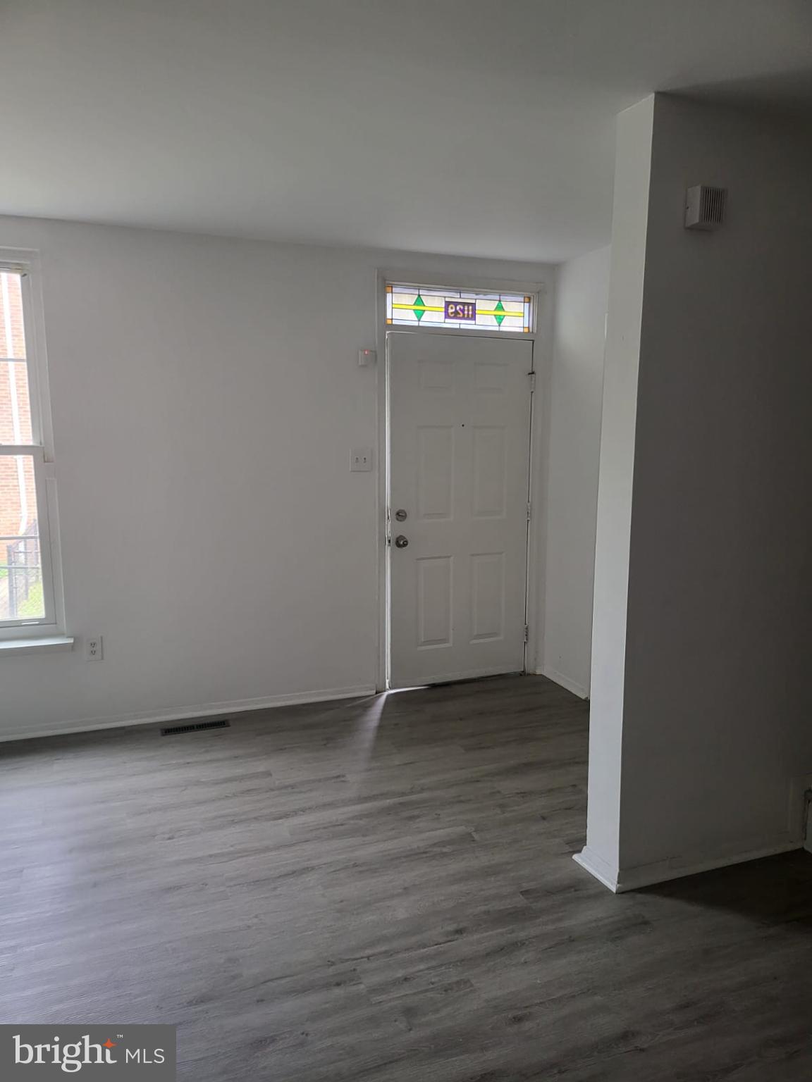 1129 Willinger Court Baltimore, MD 21202 - Photo 15 of 26 an empty room with wooden floor and windows