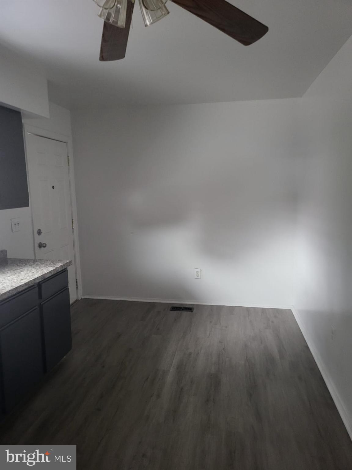 1129 Willinger Court Baltimore, MD 21202 - Photo 19 of 26 a view of an empty room and wooden floor