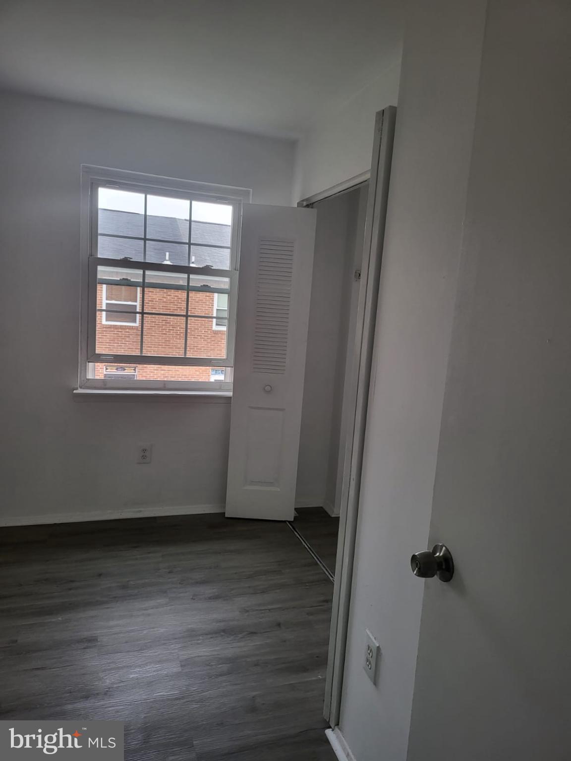 1129 Willinger Court Baltimore, MD 21202 - Photo 2 of 26 an empty room with wooden floor and windows