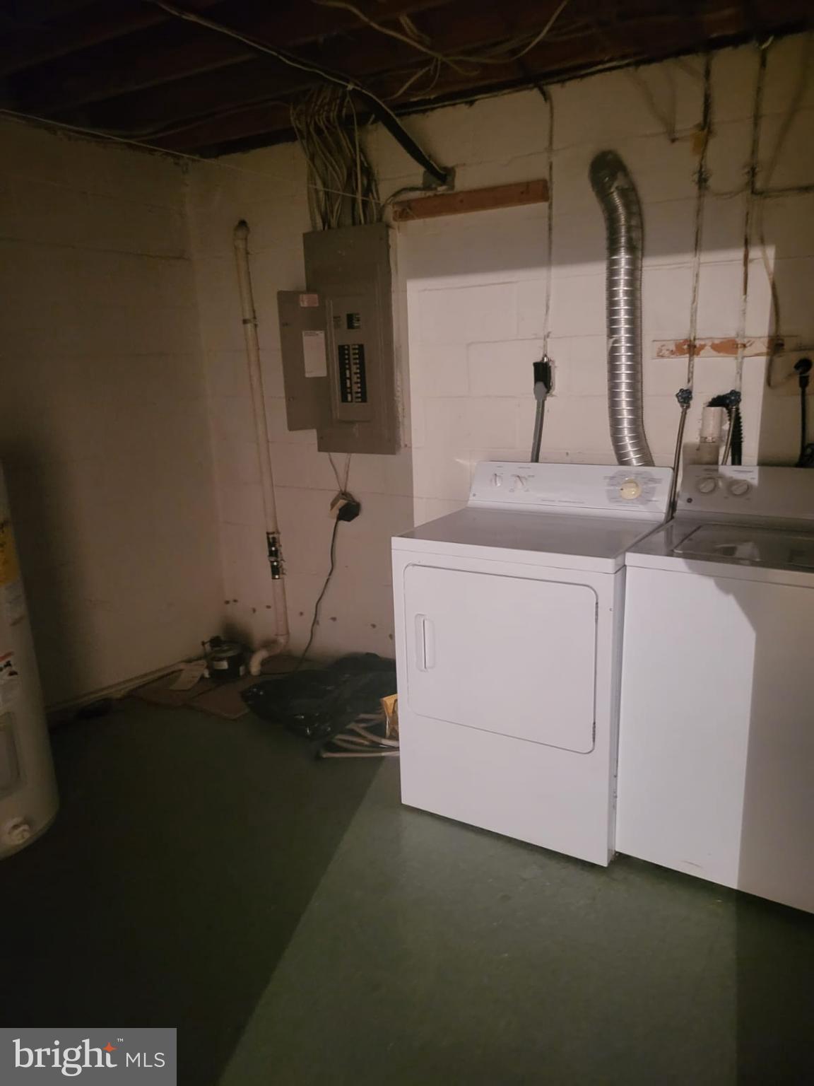1129 Willinger Court Baltimore, MD 21202 - Photo 21 of 26 a room with water heater and wooden cabinets