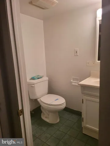 a white toilet sitting next to a sink