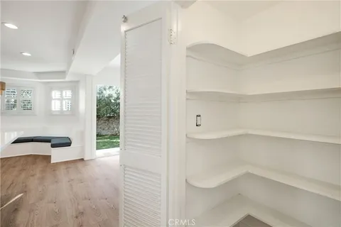 a large kitchen with kitchen island a stove a sink dishwasher and a oven with wooden floor